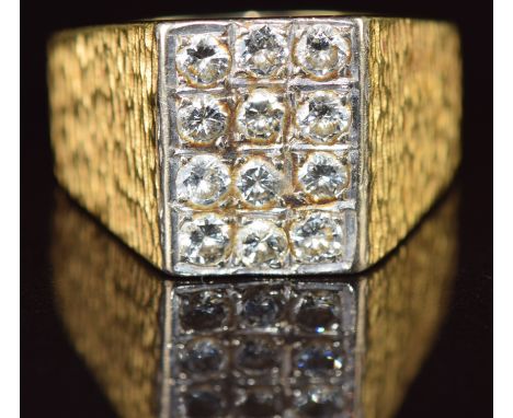 An 18ct gold ring set with twelve round cut diamonds, each approximately 0.12ct, 22.1g, size 1