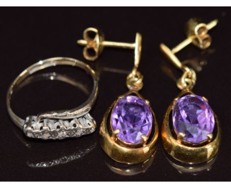 A 9ct gold ring set with five diamonds (2.2g, size M) and a pair of 9ct gold earrings each set with an oval cut amethyst (8.5