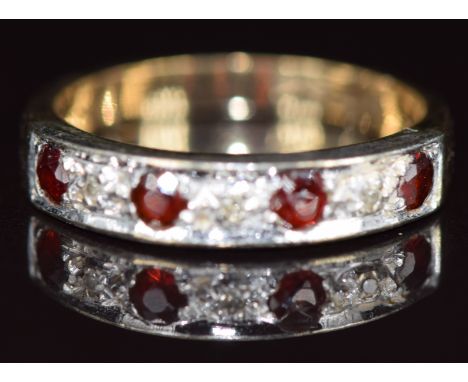 A 9ct gold ring set with garnets and diamonds, 3g, size L