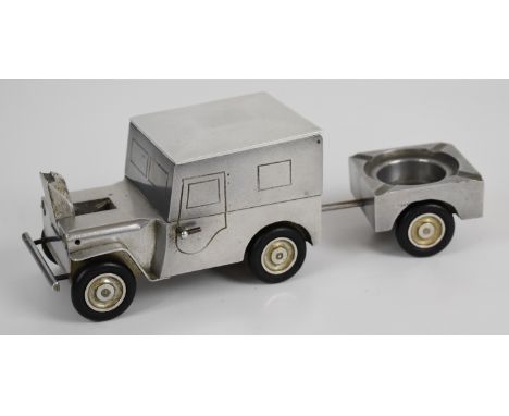 Novelty aluminium smoking compendium comprising jeep containing cigarette box to top and table lighter within the bonnet, and