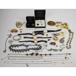 A collection of silver jewellery including rope twist necklace, elephant brooch, ring set with