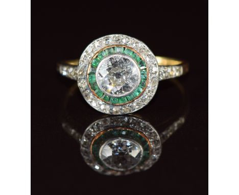 Art Deco platinum ring set with an old cut diamond of approximately 0.9ct&nbsp;surrounded by a circle of calibre cut emeralds