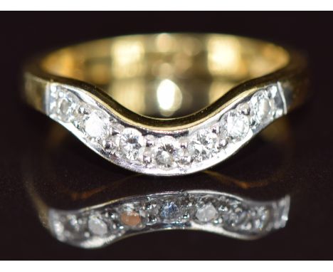 An 18ct gold ring set with diamonds in a curved setting, size N