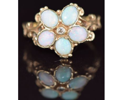 A 9ct gold ring set with opal cabochons and a diamond in a flower cluster, 3.6g, size P