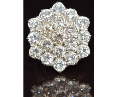 An 18ct white gold ring set nineteen round cut diamonds, each approximately 0.32ct, in a hexagonal cluster setting, the total