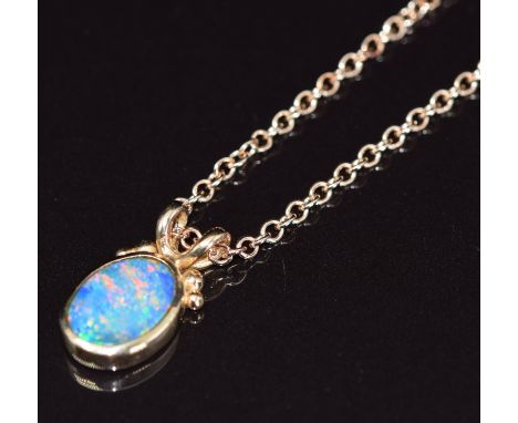 An 18ct rose gold pendant set with a black opal doublet (1.8cm) on 18ct rose gold chain, 7.4g, 44cm