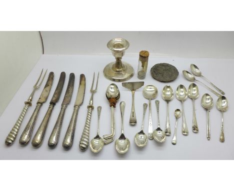 A collection of silver spoons, a candlestick, silver handled knives, a silver top, etc., weighable silver 210g 