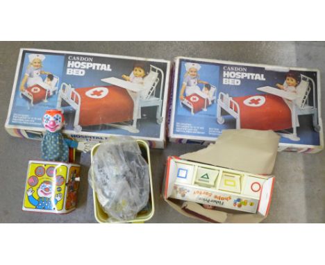 Two Casdon toy Hospital Bed Sets, boxed, a Fisher Price Shape Sorter, a Mattel Jack in the Music Box and a collection of plas