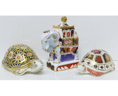 Two Royal Crown Derby tortoise paperweights, both with gold stoppers and a Royal Worcester Nelson elephant figure 