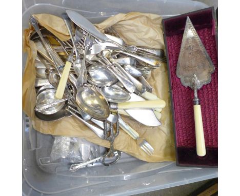 A large collection of silver plated cutlery, a pair of berry spoons, cased, and a plated ceremonial trowel dated 1909 