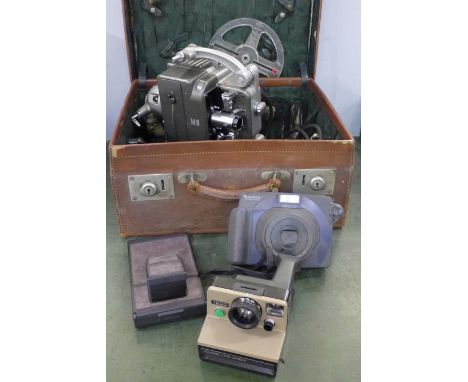 A Bolex M8 projector, a Polaroid Land Camera, a Fujifilm instax 100 camera and one other camera 