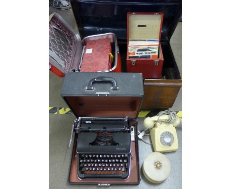 A tin trunk containing a telephone, Olympia typewriter, two cases, onyx box, shoe trees and a box of 7" singles, etc. **PLEAS