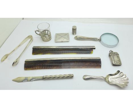 A small Victorian silver glass holder, a Victorian silver caddy spoon, a/f, a pair of silver sugar bows, a silver vesta case,