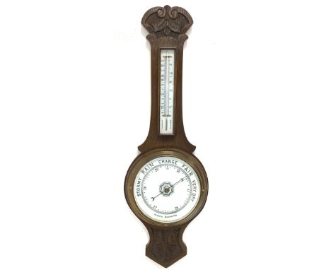 Edwardian carved oak aneroid wheel barometer and thermometer in banjo pattern case, with white porcelain registers 