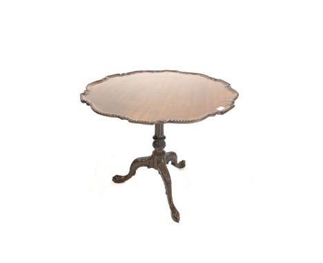 Chippendale design mahogany tilt top occasional table, with reeded column and leaf carved triple splay supports with ball and