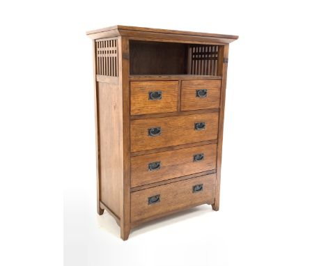  Arts and Crafts style oak chest, open shelf with slatted sides over two short and three long graduated drawers, raised on st