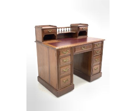 Maple &amp; Co. - Edwardian walnut pedestal desk, the raised back with spindle gallery and open shelf to centre flanked by tw