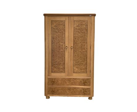 Bespoke light oak double wardrobe with figured burr oak doors enclosing two shelves, two drawers under, raised on turned supp