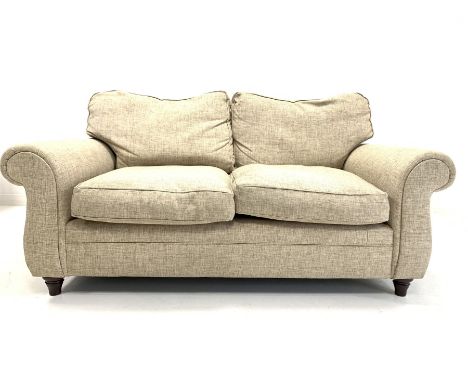 Contemporary two seat sofa, with loose cushions, upholstered in natural linen, raised on turned front supports W174cm