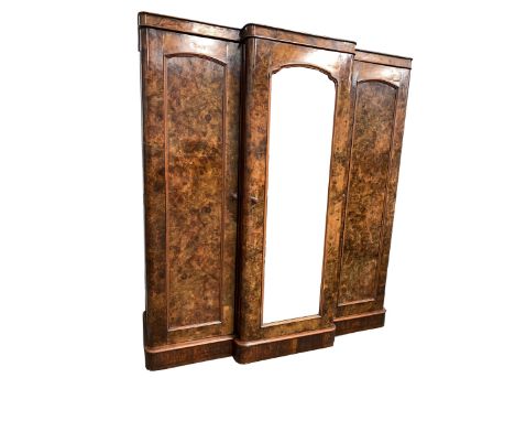 Late Victorian veneered burr walnut breakfront triple wardrobe, the centre  mirrored door enclosing four slides and three dra