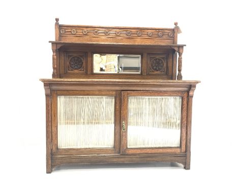 Early 20th century Arts and Crafts period oak dresser, the raised back with applied turned roundels over open shelf on turned