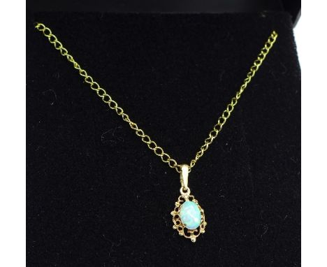 A yellow metal and synthetic opal pendant with chain