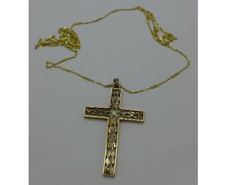 A 9ct gold cross pendant with a silver chain, weight of pendant 6g, 5.5cm