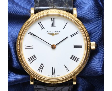 A Longines, 18k gold manual wind gentleman's wristwatch, c.1980, the white dial with black Roman numerals, the bezel with rop