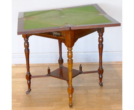 A 19th century mahogany and marquetry envelope games table, the envelope top inlaid with foliage, revealing a green baize, wi