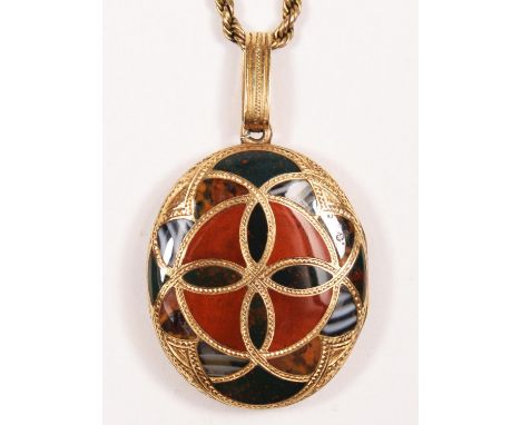 A Victorian Scottish gold and pebble oval locket, the double sided geometric design set with various hardstones, original int