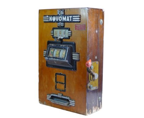 A Novomat slot machine, one arm bandit, c.1950's, works on a old 2p coin, wooden case with cast plastic front panels, highlig