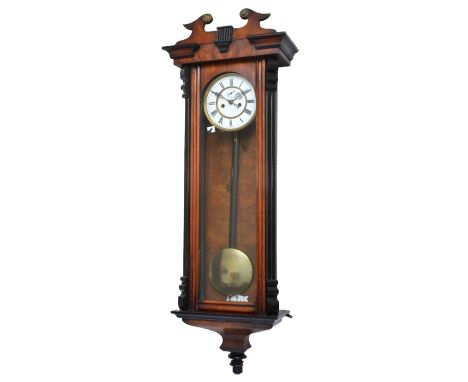 A 19th century Viennese double weight wall clock, the two part white enamel dial with Roman numerals, the unsigned movement s
