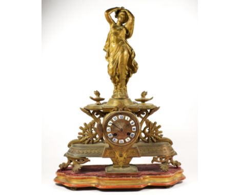 A 19th century French gilt metal mantel clock, the dial with applied white enamel Roman numerals, the case with classical lad