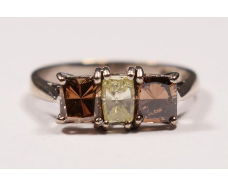 An 18ct white gold three stone diamond ring ring, claw set with a yellow stone of approximately 0.40cts flanked by brown ston