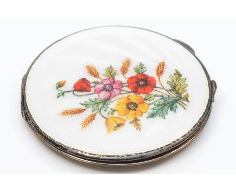 A silver and enamel powder compact, Birmingham 1940, floral decoration with white guilloche enamel background, lacking powder