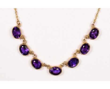 A Victorian style 9ct gold and amethyst necklace, Birmingham 1967, collet set with seven mixed cut stones of very good colour