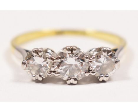 An 18ct gold three stone diamond ring, claw set with graduated brilliant cut stones, approximately 0.30, 0.50, 0.30cts, colou