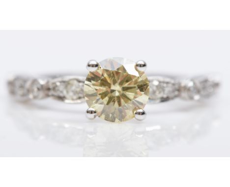 A 14K white gold single stone natural fancy yellow brilliant cut diamond ring, AIG certificate number J3030060921, grade stat