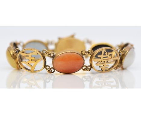 A Chinese 14K gold, jade and hardstone panel link bracelet, collet set with cabochon stones, character panels between, 18.5cm
