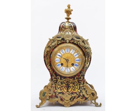 A 19th century French boulle mantel clock, the gilt dial with white enamel numerals, the shaped case with red tortoiseshell a