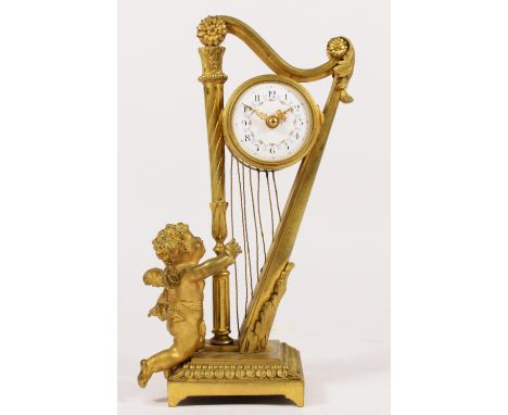 A 19th century French gilt brass mantel clock, the white enamel dial with a floral garland, with a winged cherub playing harp