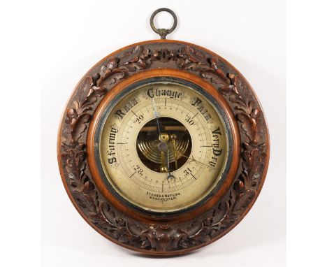 Stokes & Watson, Manchester, Victorian oak aneroid barometer, the signed 7 inch silvered dial within an acorn and oak leaf fr
