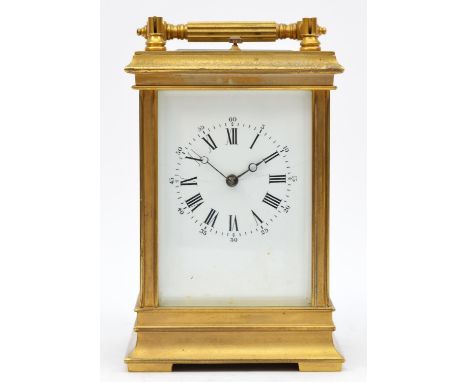 A brass repeating and striking carriage clock, the white enamel dial with Roman numerals, the unsigned movement striking the 
