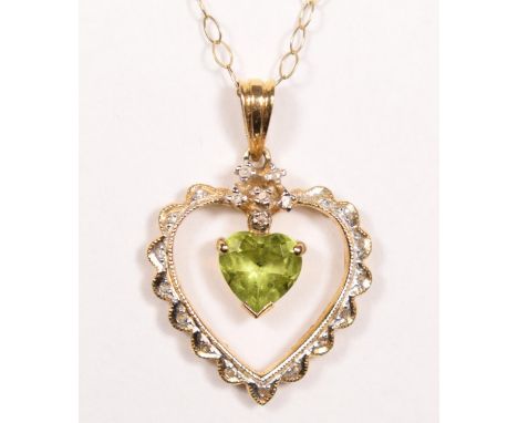 A 14k gold peridot and diamond pendant, claw set with an articulated stone, 24 mm overall, 9ct gold chain, 1.9gm.