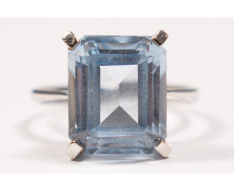 A white gold and synthetic blue spinel ring, tests as 18ct gold, claw set with an emerald cut stone, 12 x 10mm, N, 4.3gm.