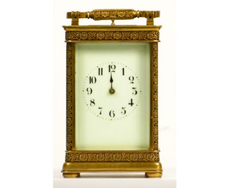 A brass repeating and striking carriage clock, the dial with Arabic numerals, the case with applied floral border, the unsign