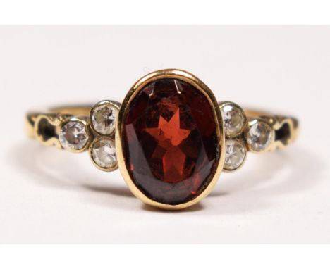 A 9ct gold, garnet and brilliant cut diamond ring, collet set with an oval mixed cut stone, trefoil shoulders, N, 2.8gm.