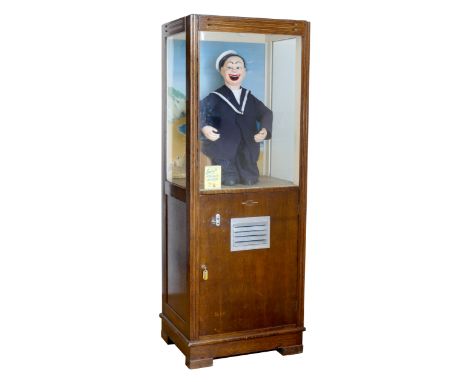 A coin operated arcade automaton, Laugh with Jolly Jack, wooden case with three glazed sides, above a hinged door (includes k