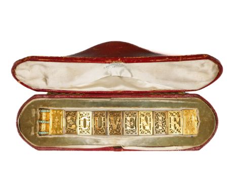 A Victorian gold turquoise book bracelet, retailed by John Brogden, composed of pierced and engraved panel spelling SOUVENIR,