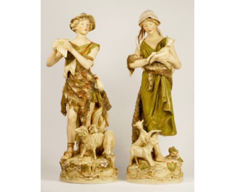 A Royal Dux pair of Shepherd playing the pipes, number 570, and Shepherdess with goats, number 580, pink triangle mark and im